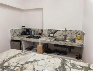 a kitchen with marble counter tops and a sink at Casa Tamarindo in San Carlos
