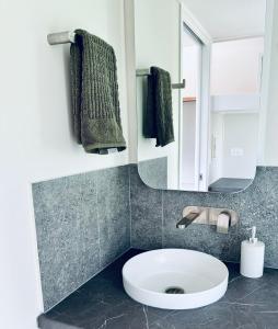 a bathroom with a sink and a mirror at Cape Byron Cabin in Coorabell Creek +14 photos