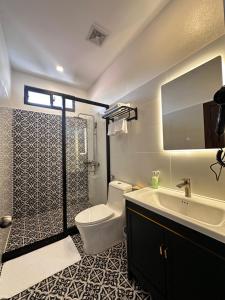 a bathroom with a toilet and a sink and a tub at The TARA PRABANG - Luangprabang in Luang Prabang