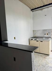 a kitchen with a stove and a counter top at Flat Recanto Brados in Sao Jorge +2 photos