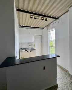 a kitchen with a black counter top in a room at Flat Recanto Brados in Sao Jorge