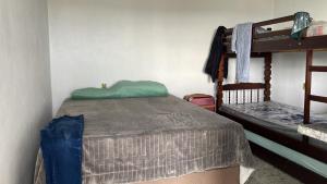 a bedroom with a bed and bunk beds at Flat Recanto Brados in Sao Jorge