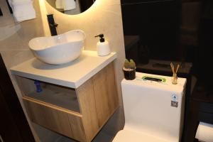 a bathroom with a bowl sink on a counter at Ramon Luxury Suites in Gualaceo +28 photos