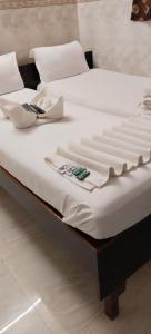 two beds sitting next to each other in a room at Hotel Kamal in Mumbai