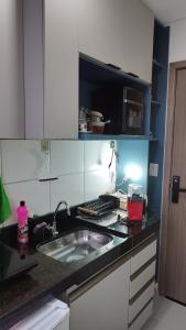 a kitchen with a sink and a counter top at Studio moderno e bem localizado in João Monlevade