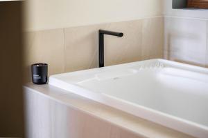 a white bath tub with a black cup on a counter at 25 Walkers Lane in Bright