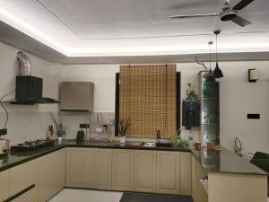 a kitchen with white cabinets and a black counter top at IMSONG'S humble abode in Dimapur