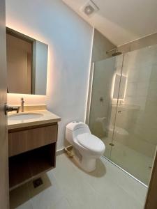 a bathroom with a toilet and a sink and a shower at BQ84 Urban Hotel in Barranquilla