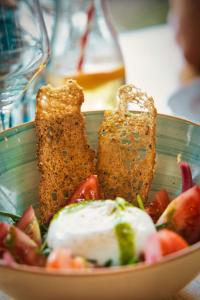 a plate of food with bread and fruit on a table at Beachhouse Isleten in Bauen +28 photos