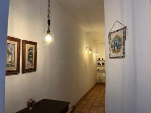 a hallway with a table and a picture on the wall at Canto do Florescer in Pesqueira