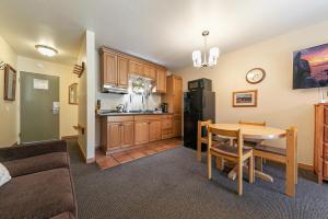 a living room with a kitchen and a dining room table at Cozy Studio wKitchen #217 at Donner Lake Village in Truckee
