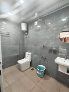 a bathroom with a toilet and a sink at Sleek Haven in Meppādi