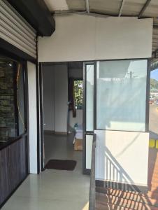 an open entrance to a house with a glass door at Sleek Haven in Meppādi