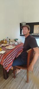 a man in a hat sitting at a table at Moonlit serenity Tangalle in Tangalle