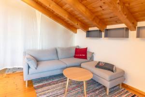 a living room with a blue couch and a table at Bergzitt in Ofterschwang