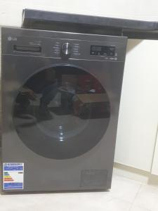 a black washing machine with its door open at سي فيو سان ستفانو in Alexandria