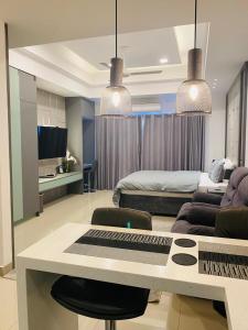 a living room with a couch and a table with a keyboard at Coastal Cocoon Studio - Negombo in Negombo