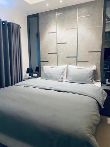 a bedroom with a large bed with white sheets and pillows at Coastal Cocoon Studio - Negombo in Negombo +35 photos
