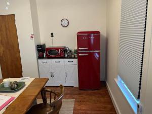a red refrigerator in a kitchen with a table at The Acorn at Oak Lodge in Palenville +10 photos