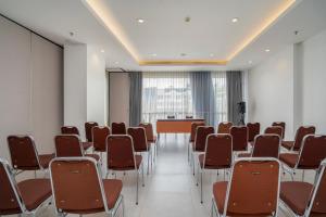 a conference room with chairs and a podium in it at JP Hotel Pluit Jakarta by LIFE in Jakarta