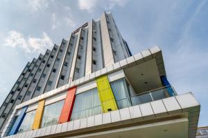a building with colorful doors on the side of it at JP Hotel Pluit Jakarta by LIFE in Jakarta +9 photos