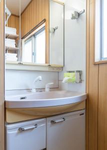 a bathroom with a sink and a mirror at 屋島base-最大10名 in Takamatsu +39 photos