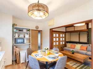 a living room with a table and a couch at 屋島base-最大10名 in Takamatsu