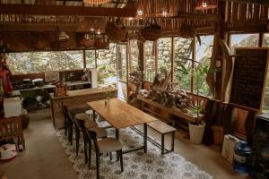 a dining room with a wooden table and chairs at Sapa Ta Van Desi House - Mountain View & Hiking Tours in Sapa