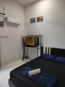 a bedroom with a bed with a towel on it at Penarik baru homestay in Kampung Penarik +41 photos