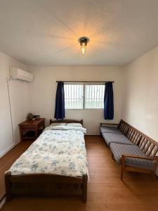 a bedroom with two beds and a window at P-house Yumearu in Sobe