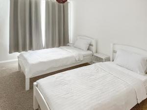 a bedroom with two beds and a window at Thirslet in Maldon