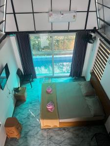 a room with a bed and a swimming pool at Zerahs Private Pool Villa, Athirappilly - Extra upstair Bed space in Athirappilly