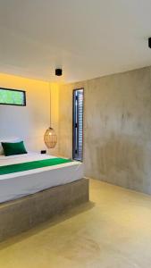 a bedroom with a bed and a window at Three Tree Villa By Habarana in Habarana