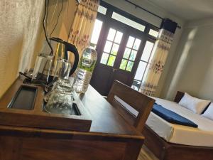 a bedroom with a bed and a table with a table at Aroma Holiday Home-Haputhale in Haputale