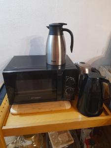 a coffee pot sitting on top of a toaster oven at Casa 1885 in Belluno