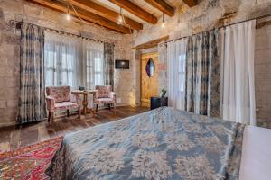 a bedroom with a bed and a table and chairs at Panoramic Cave Hotel in Goreme