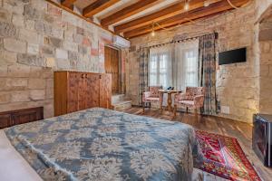 a bedroom with a bed and a table with chairs at Panoramic Cave Hotel in Goreme
