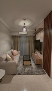 a living room with a couch and a tv at Apartment In Central Jakarta in Jakarta
