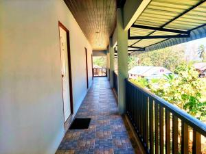 an empty hallway of a house with a balcony at Heimat Garden Homestay in Ban Lo Pa Ret
