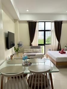 a living room with a couch and a table at Mactan Plains Studio Unit in Punta Engaño