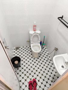 a small bathroom with a toilet and a sink at Serai Homestay in Dungun +10 photos