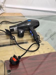 a blow dryer sitting on top of a wooden floor at Sameer Mountain View Glamping in Cameron Highlands +5 photos