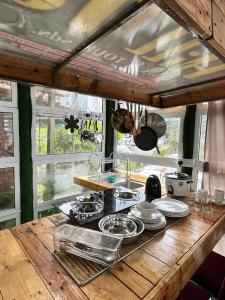 a kitchen with a wooden counter top with plates and pans at Sameer Mountain View Glamping in Cameron Highlands