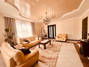 a living room with two couches and a table at vila in CHAKVI in Chakvi