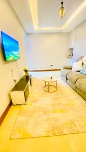 a living room with a couch and a table at Urban Host Buru Prime 1BR Luxe in Nairobi