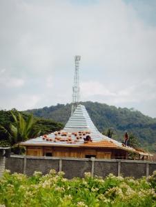 a building being constructed with a pyramid roof at Dooz's place - Selong belanak in Selong Belanak