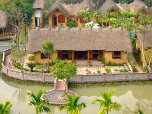 a model of a house with a thatch roof at The Bổi Heritage Tam Coc in Ninh Binh