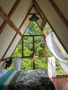 a room with a large window in a tent at Cabañas Metztonalli in Xilitla
