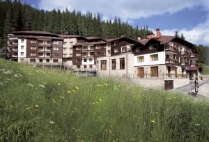 a large building on the side of a hill at Edelweiss Mountain Apartment - Stream Resort Spa & Pool, Pamporovo in Pamporovo