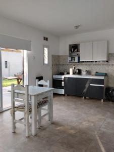 a kitchen with a table and chairs in a room at Quinta don josé in Luján